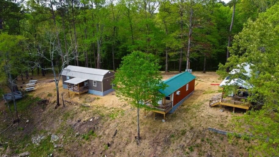 Aerial view of Lucky's three cabins in the wooded hills near the Caddo River
